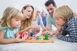 Eltern, die mit ihren beiden Kindern ein Brettspiel spielen. Eltern, die mit ihren beiden Kindern ein Brettspiel spielen.